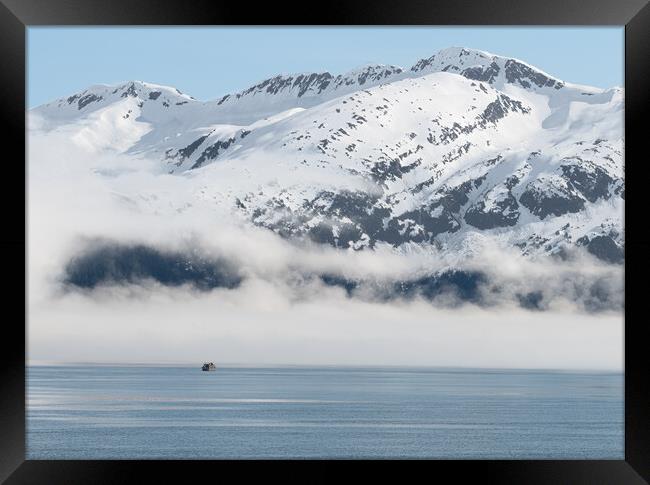 Boat approaching fog on the mountains and sea in Passage Canal, Whittier, Alaska USA Framed Print by Dave Collins
