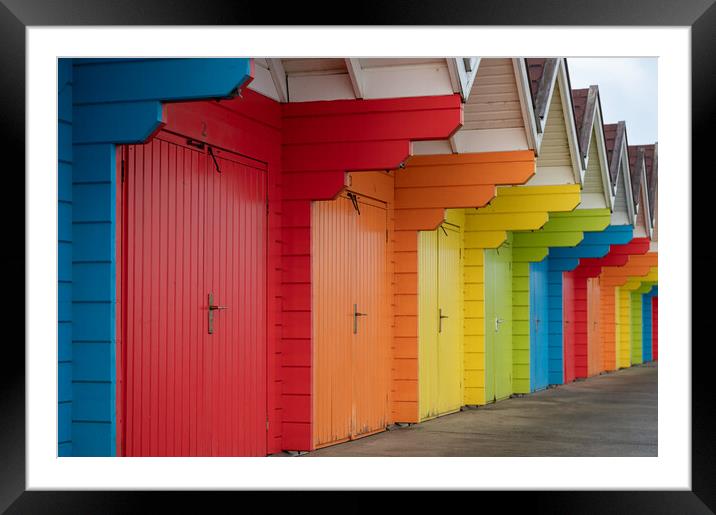 Colourful beach huts (de-focused near and far)  in a row on Scarborough North Bay Beach, Yorkshire, England Framed Mounted Print by Dave Collins
