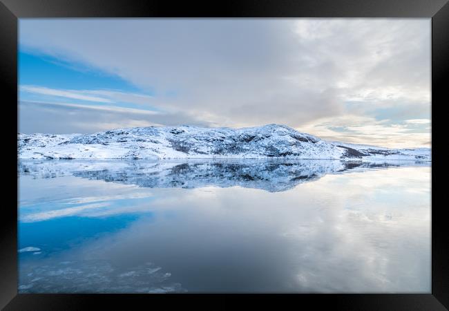 Norway - snow on an island in a smooth sea Framed Print by Dave Collins