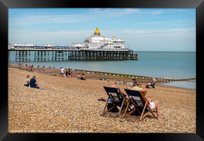 Deck chairs on Eastbourne Beach & Pier Framed Print by Dave Collins