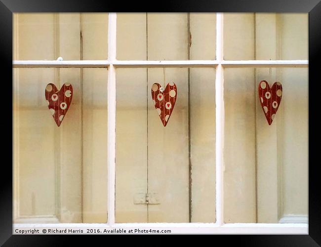 Decorative hearts displayed inside shuttered windo Framed Print by Richard Harris