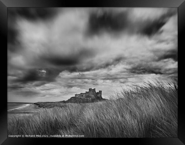 Gathering storm over Bamburgh Castle Framed Print by Richard Pike