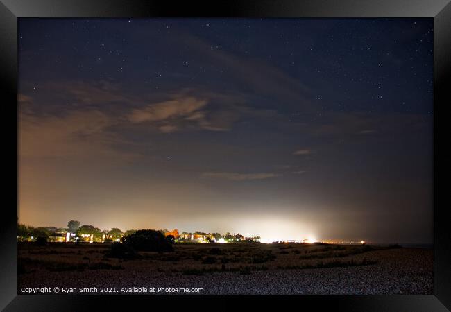 Coastal town under a starry sky Framed Print by Ryan Smith