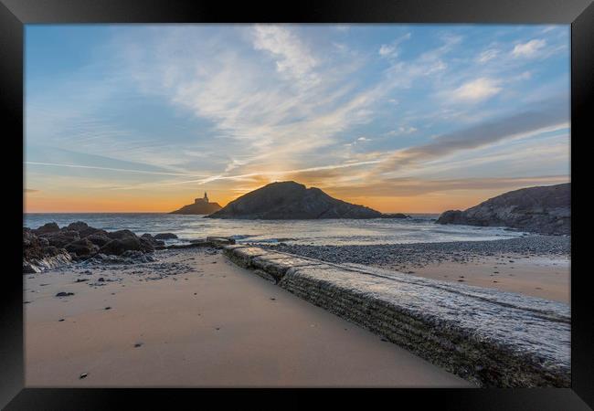 Sunrise at Mumbles lighthouse from the small bay. Framed Print by Bryn Morgan