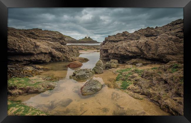 Mumbles lighthouse viewed from a rock pool. Framed Print by Bryn Morgan