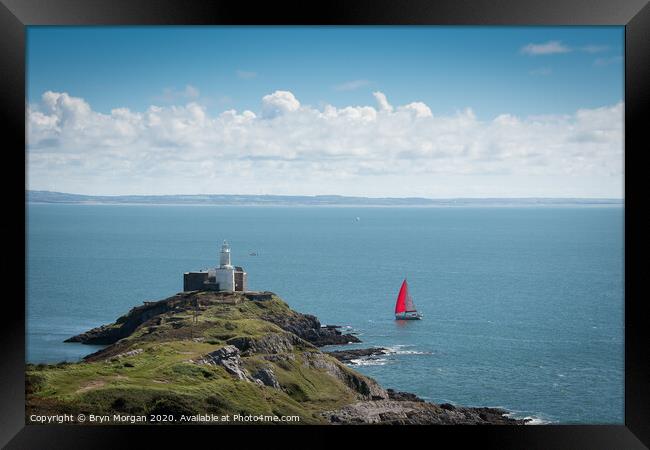 Yacht passing Mumbles lighthouse Framed Print by Bryn Morgan