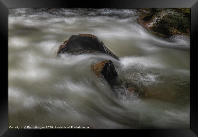 Boulder with flowing water Framed Print by Bryn Morgan