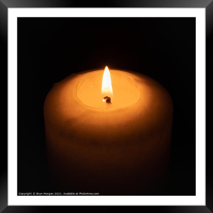 Burning candle in the darkness Framed Mounted Print by Bryn Morgan