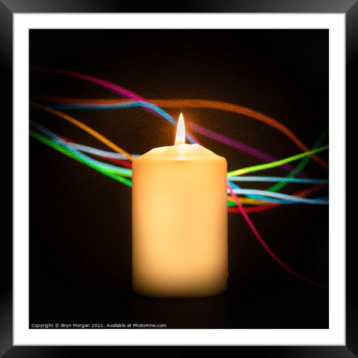 Burning candle with streaks of coloured light Framed Mounted Print by Bryn Morgan