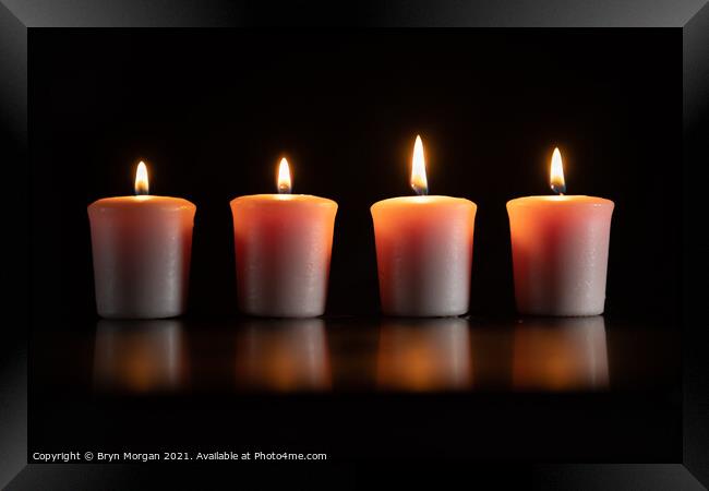 Four burning candles Framed Print by Bryn Morgan