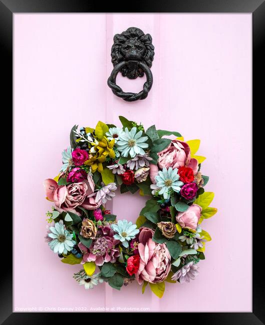 Wreath on a Pink Door Framed Print by Chris Dorney