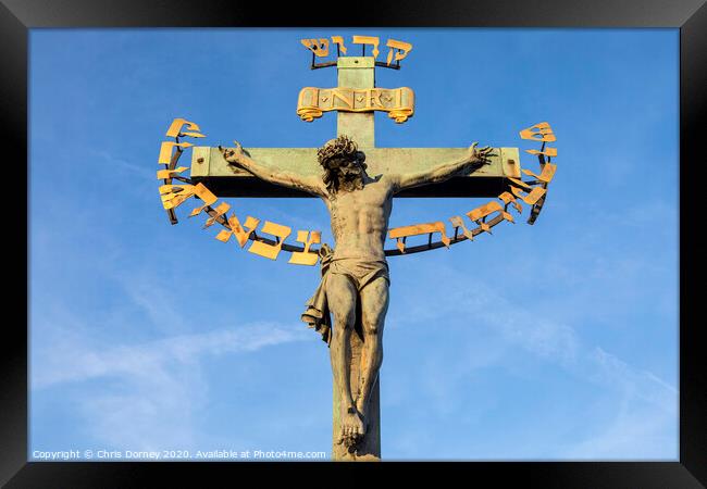 Crucifix on the Chales Bridge in Prague Framed Print by Chris Dorney