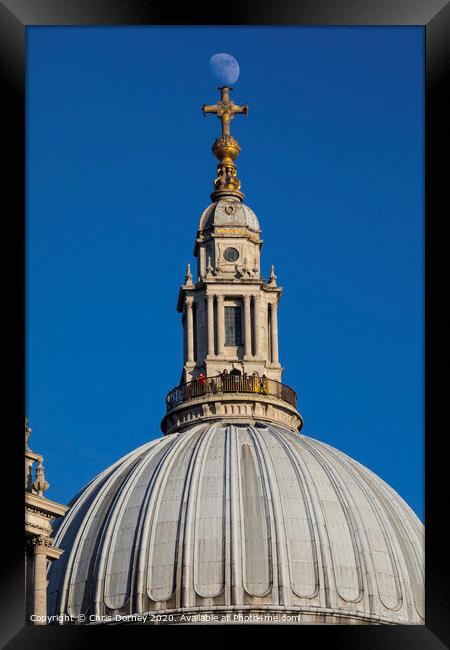 The Moon Perched on St. Pauls Cathedral Framed Print by Chris Dorney