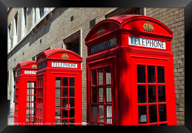 Red Telephone Boxes in London Framed Print by Chris Dorney