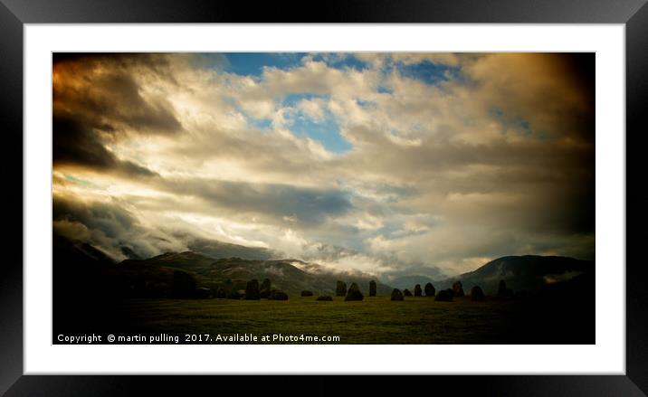 moody sky over the stones Framed Mounted Print by martin pulling