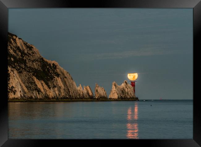 Moon setting over lighthouse Framed Print by Alf Damp