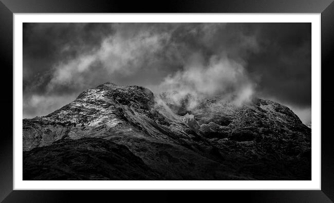 Langdales, Lake District covered in snow and cloud Framed Print by Graham Binns