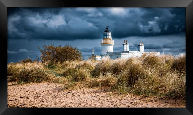 Storm Clouds gather over Chanonry Point Lighthouse Framed Print by John Frid