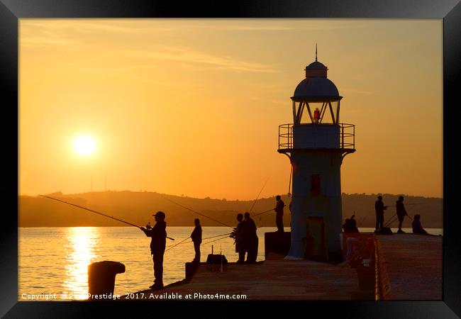 Anglers at Brixham Breakwater Lighthouse at Dusk Framed Print by Paul F Prestidge