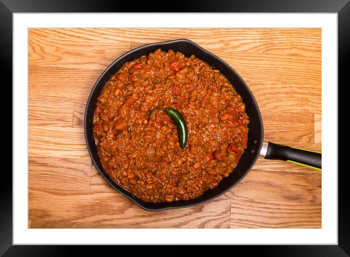Chili in Black Pan on Wood Table with Jalapeno Pep Framed Mounted Print by Darryl Brooks