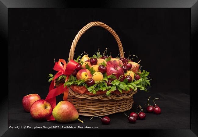Basket with fresh fruits and berries on a black background Framed Print by Dobrydnev Sergei
