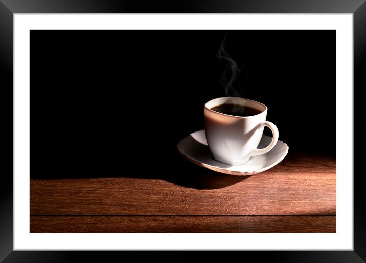 White cup of hot coffee on the table and a deep da Framed Mounted Print by Dobrydnev Sergei
