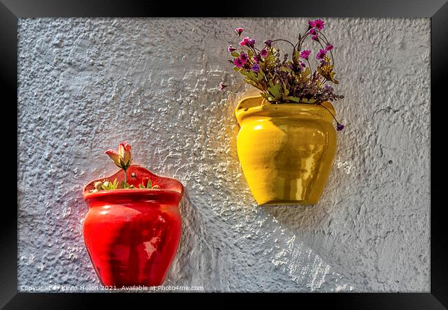 Colourful plantpots with flowers hanging on a wall, Framed Print by Kevin Hellon