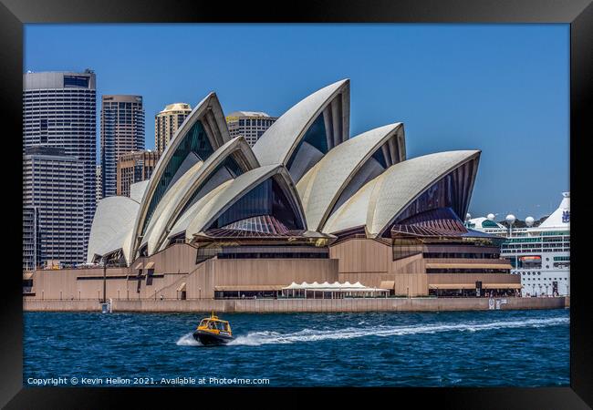 A boat powers past the Sydney Opera House, in the  Framed Print by Kevin Hellon
