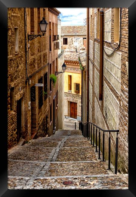 Steep, narrow street in Toledo, Spain Framed Print by Kevin Hellon