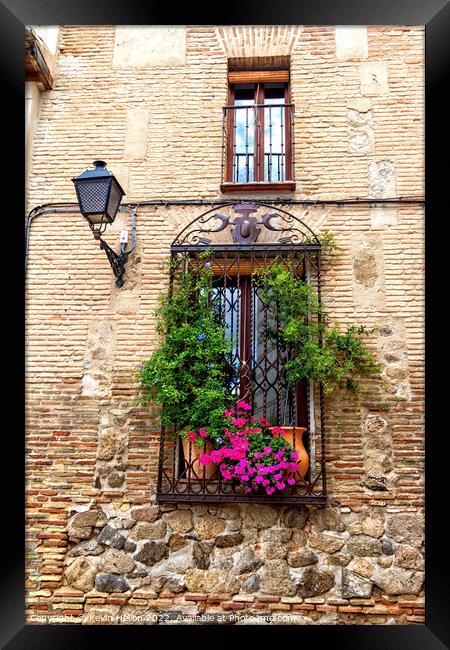 Window with flowers in old house in Toledo, Spain Framed Print by Kevin Hellon