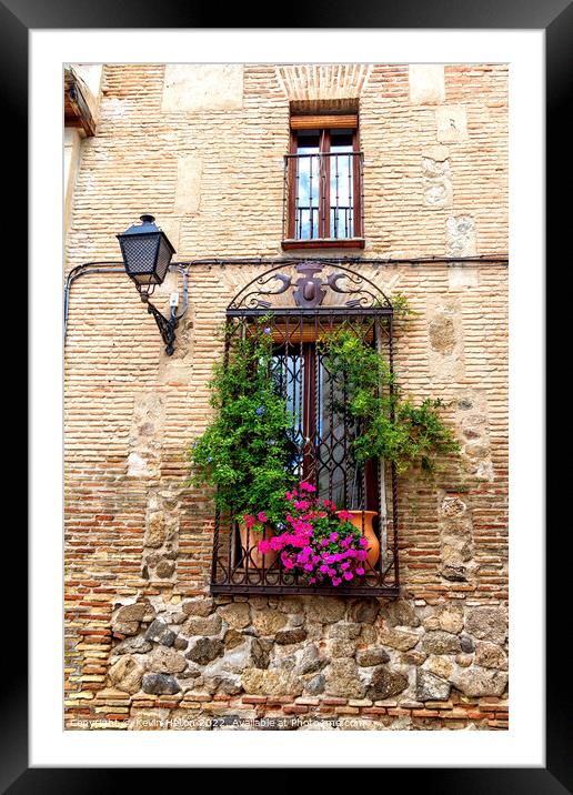 Window with flowers in old house in Toledo, Spain Framed Mounted Print by Kevin Hellon