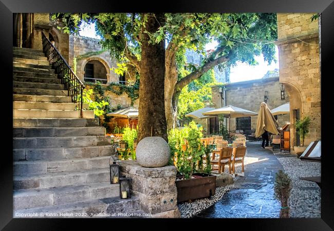 Sunny courtyard in Rhodes Town, Greece Framed Print by Kevin Hellon