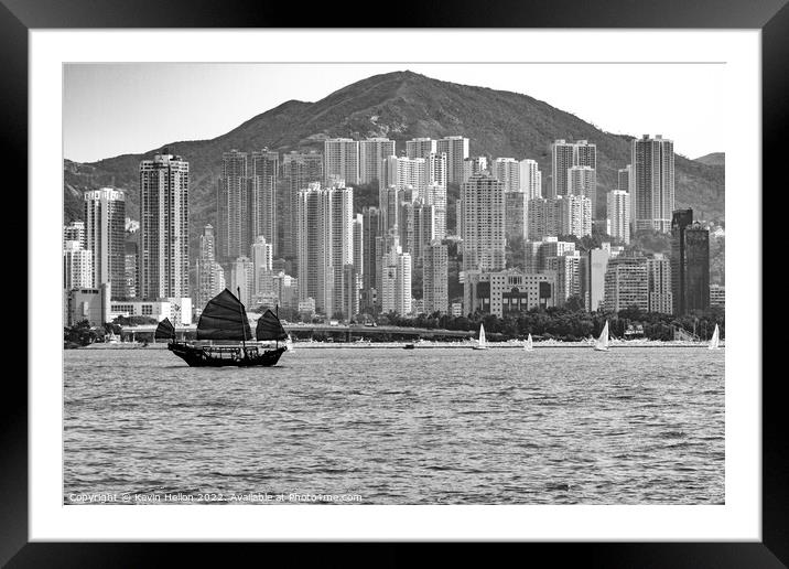 Junk sailing in Victoria Harbour, Hong Kong Framed Mounted Print by Kevin Hellon