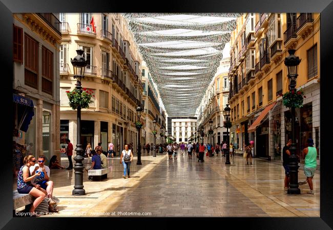 People shopping on Marques de Larios. Framed Print by Kevin Hellon