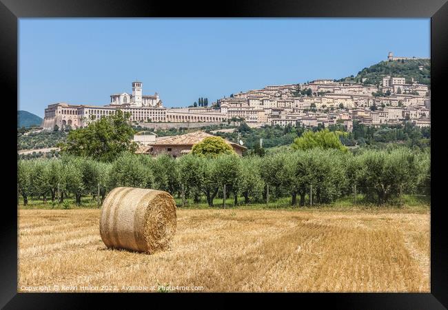 Hay roll overlooked by the Basilica di San Francesco D'Assisi, U Framed Print by Kevin Hellon