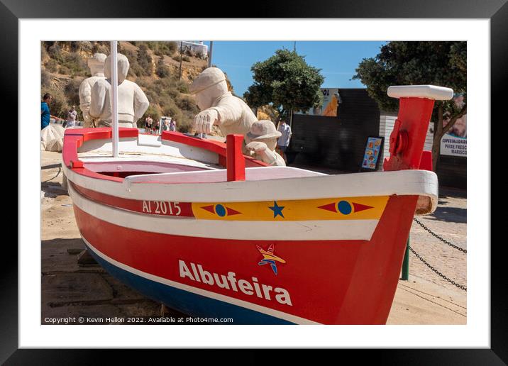 Boat and stone statues, Albufeira old town, Framed Mounted Print by Kevin Hellon