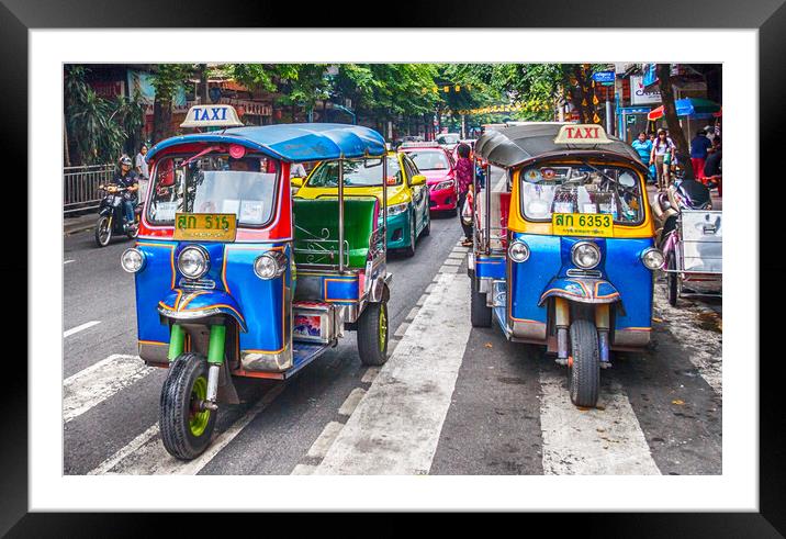 Tuk tuks on a street in the city. Framed Mounted Print by Kevin Hellon