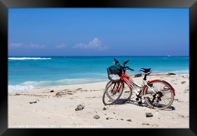 Bicycles on a white sand beach Framed Print by Kevin Hellon