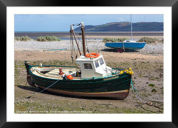 Boats moored in Red Wharf BayAnglesey at low tide. Framed Mounted Print by Kevin Hellon