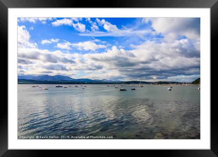 Blue sky and clouds over boats moored in the Menai Framed Mounted Print by Kevin Hellon