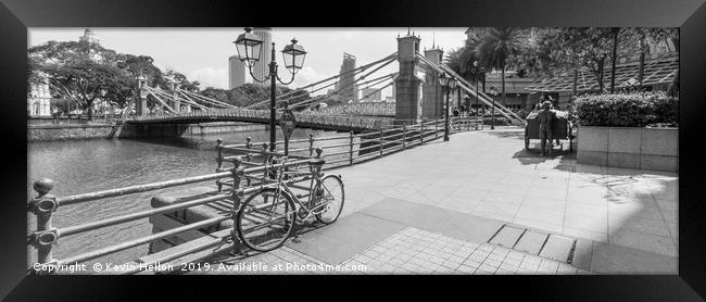 Bicycle leaning against railings with Cavenagh Bri Framed Print by Kevin Hellon