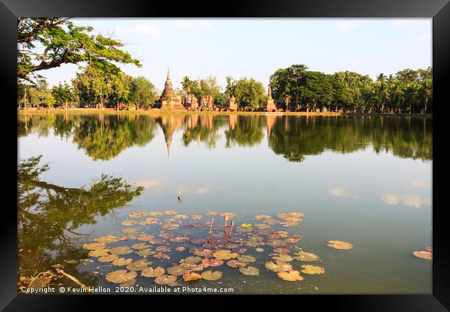 Stupas reflected in the lake  Framed Print by Kevin Hellon