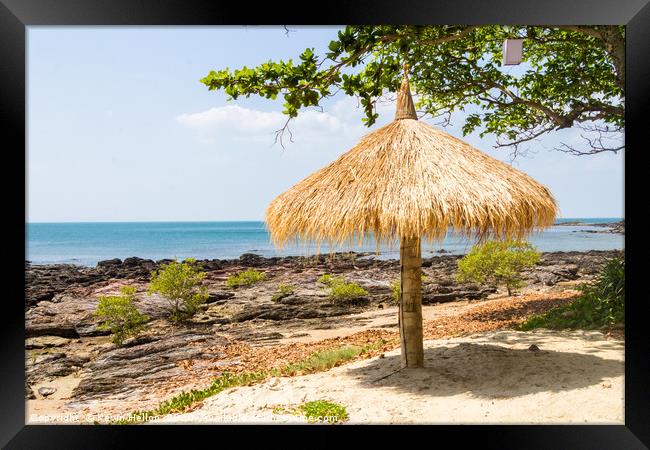 Straw parasol on beach with rocks, Kho Lanta, Thai Framed Print by Kevin Hellon