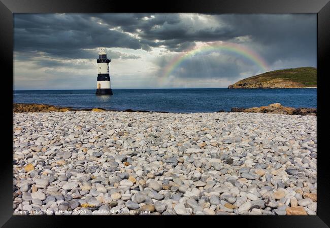Penmon lighthouse and shingle beach with rainbow Framed Print by Kevin Hellon