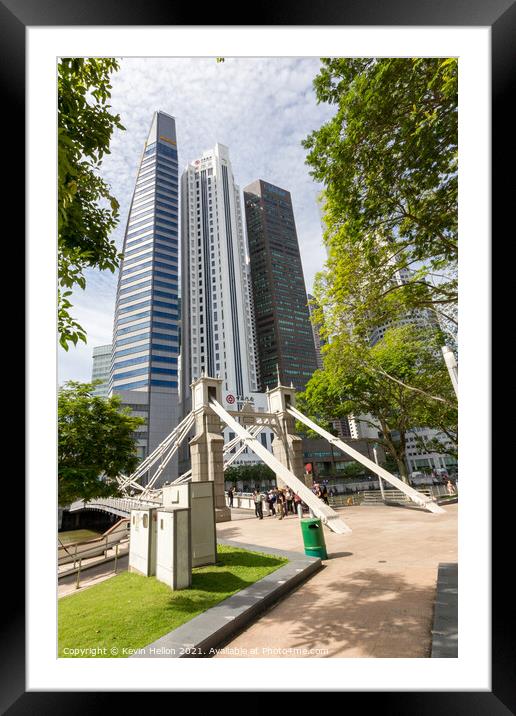 The Cavenagh bridge with the Bank of China and other buildings i Framed Mounted Print by Kevin Hellon