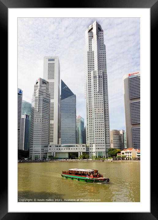 Bumboat on the Singapore river with the tall buildings of the fi Framed Mounted Print by Kevin Hellon