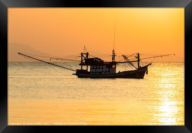 Fishing boat at sunset Framed Print by Kevin Hellon