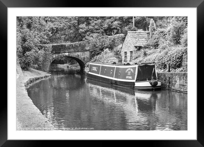 Barge moored next to a bridge Framed Mounted Print by Kevin Hellon