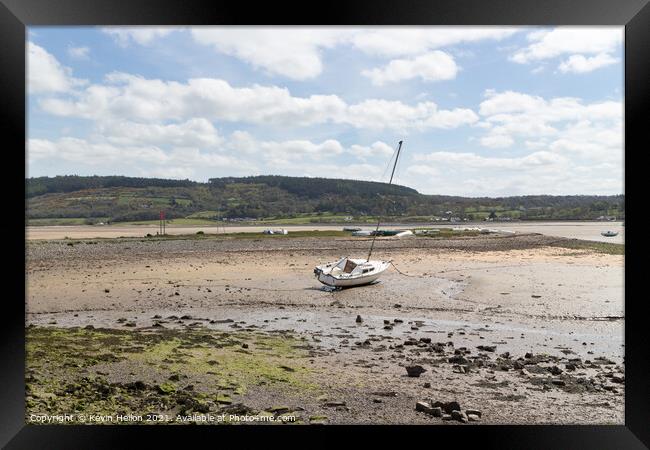 Boats moored in Red Wharf BayAnglesey at low tide. Framed Print by Kevin Hellon