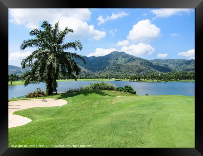 View of lake and palm tree Framed Print by Kevin Hellon